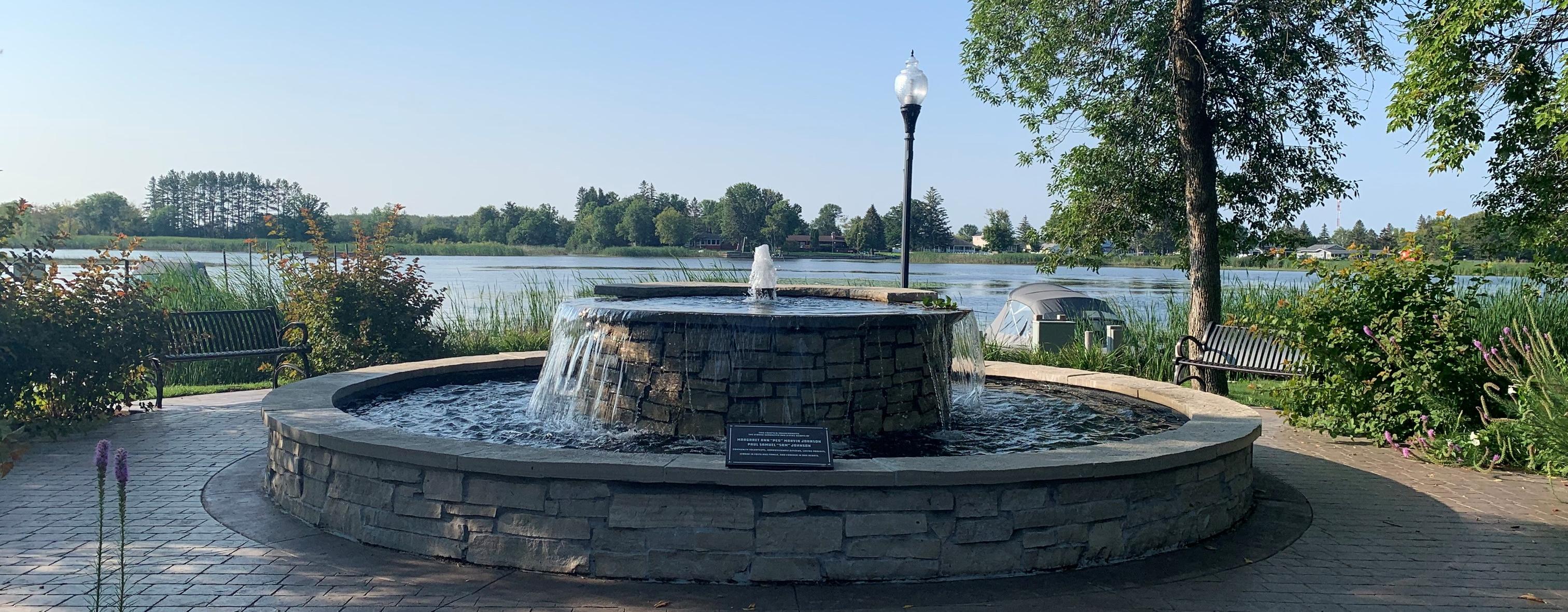 fountain in partk next to lake